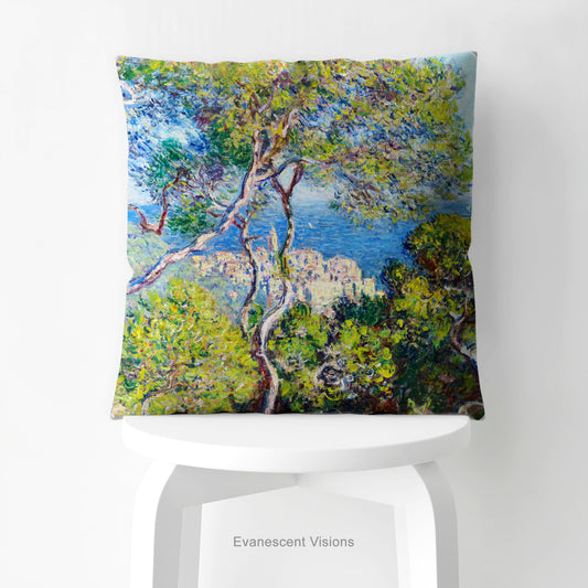 A square decorative cushion printed with with Monet's Bordighera painting, on white stool