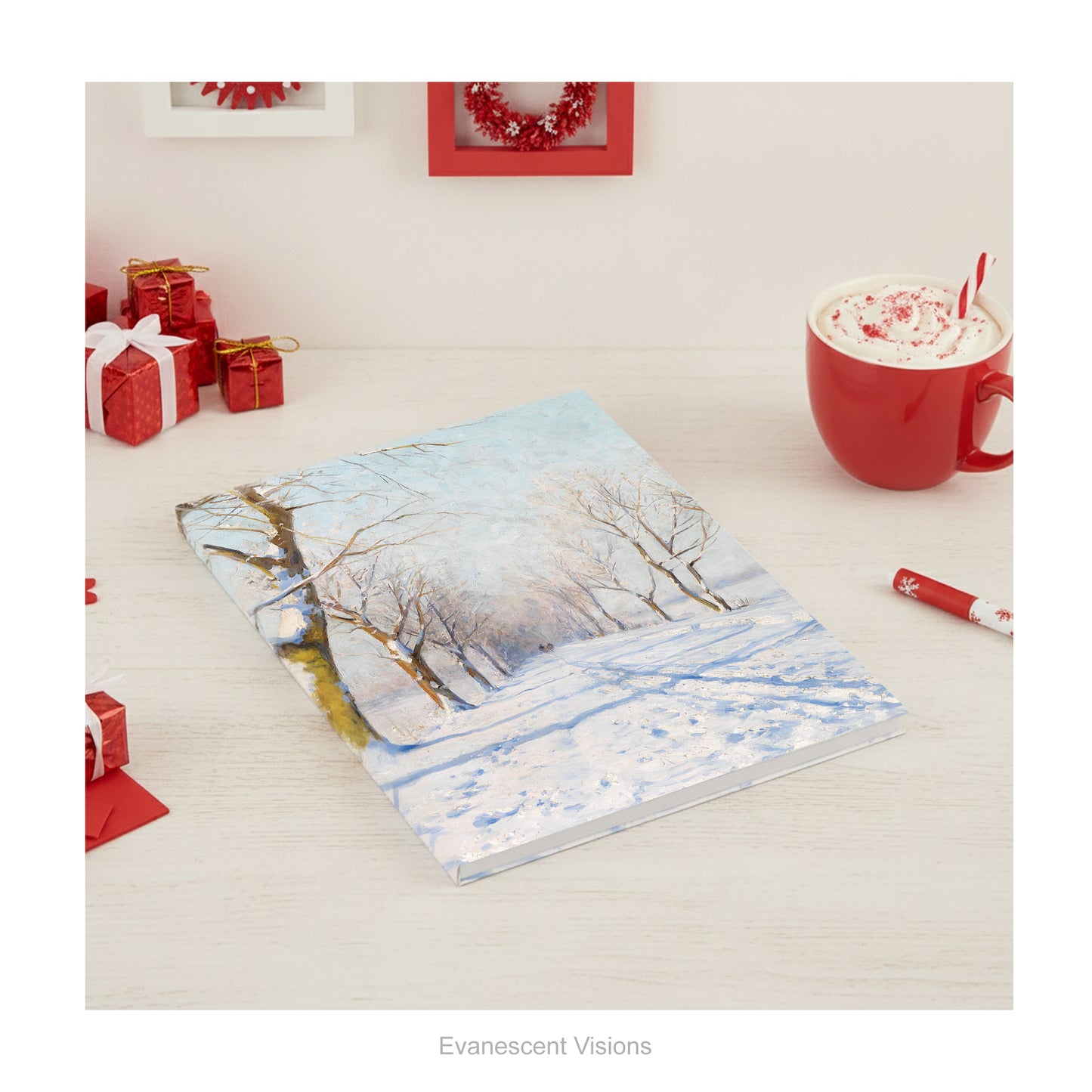 A hardback notebook featuring a winter landscape from painting A Sunny Winters Day by Walter Moras, shown on a wood desk.