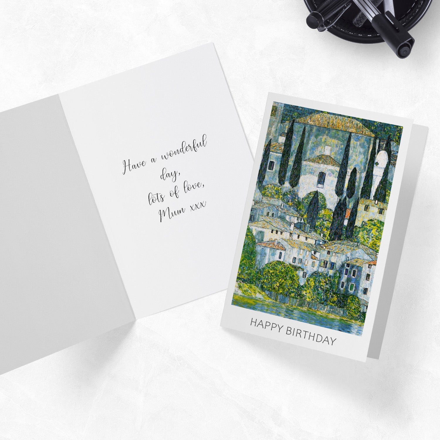 Evanescent Visions art greeting cards laying on a desk with pens