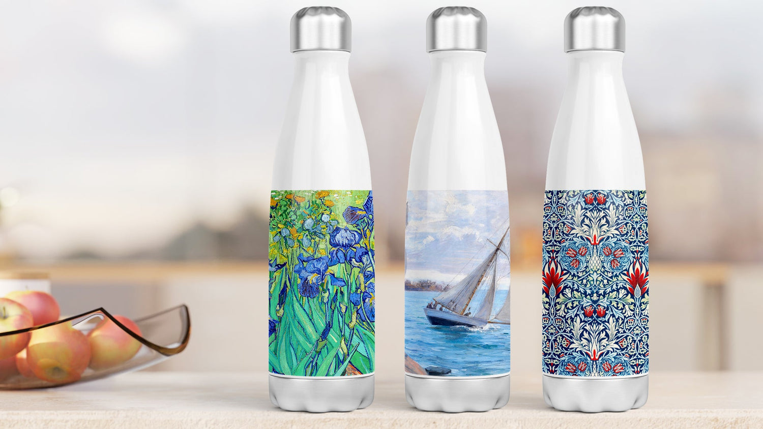 Three stainless steel water or thermos bottles on a kitchen counter