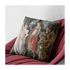 A square decorative cushion with a print of the classical painting 'La Primavera' by Sandro Botticelli, shown on a red armchair.