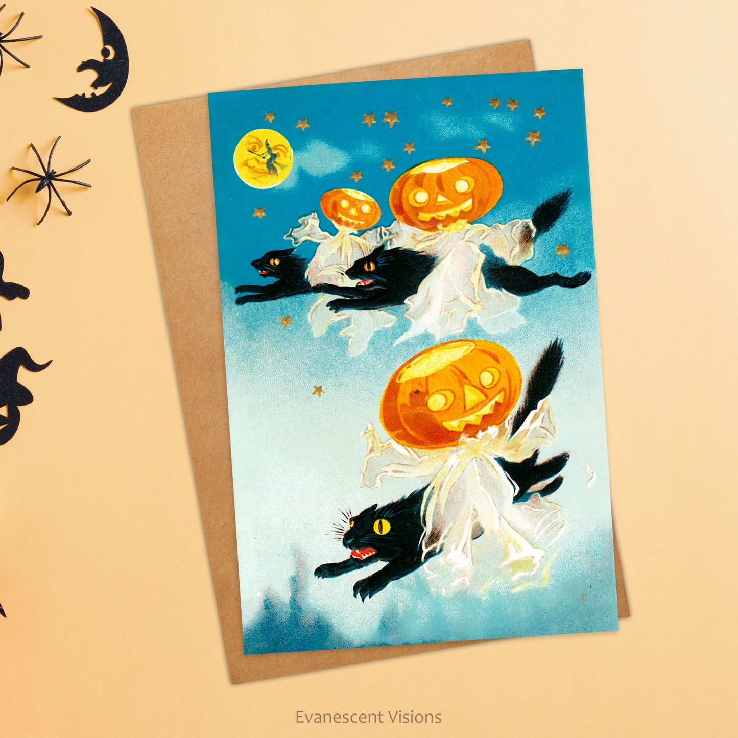 Card shows vintage image with black cats, jack o' lanterns and moon with witch on broomstick. Envelope also shown, both against background with halloween fun accessories.