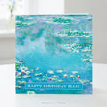 A square greeting card featuring Claude Monet Water Impressionist Water Lilies Painting standing upright on a table. 