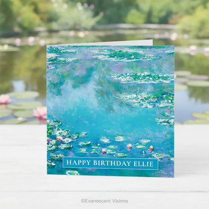 A square greeting card featuring Claude Monet Water Impressionist Water Lilies Painting standing upright on a table in front of a water lily pond.