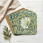 Set of 4 stacked coasters with detail from design 'Pimpernel' by William Morris, styled on a white wood background.