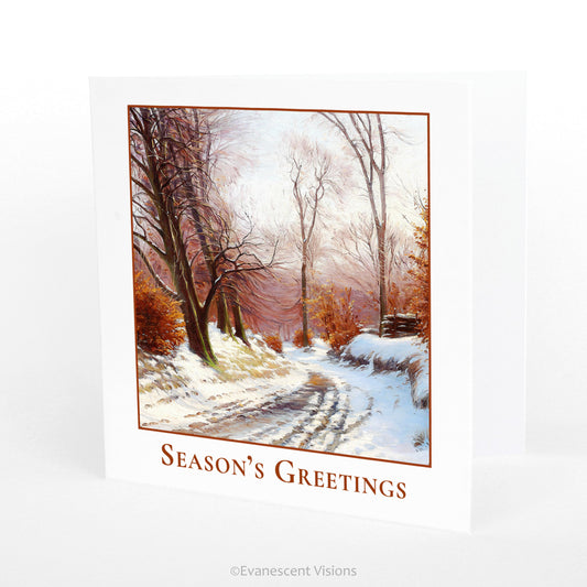 Winter Road Season's Greetings Traditional Christmas Card with artwork  'The Road to Ørholm' by Sigvard Hansen, with the card standing on a table.