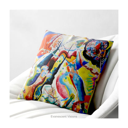 A square cushion featuring a print of the  abstract, multicolored painting 'Bild mit Rotem Fleck' by Wassily Kandinsky, shown on a white chair. 