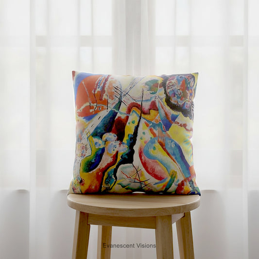A square cushion featuring a print of the  abstract, multicolored painting 'Bild mit Rotem Fleck' by Wassily Kandinsky, shown on a brown stool.