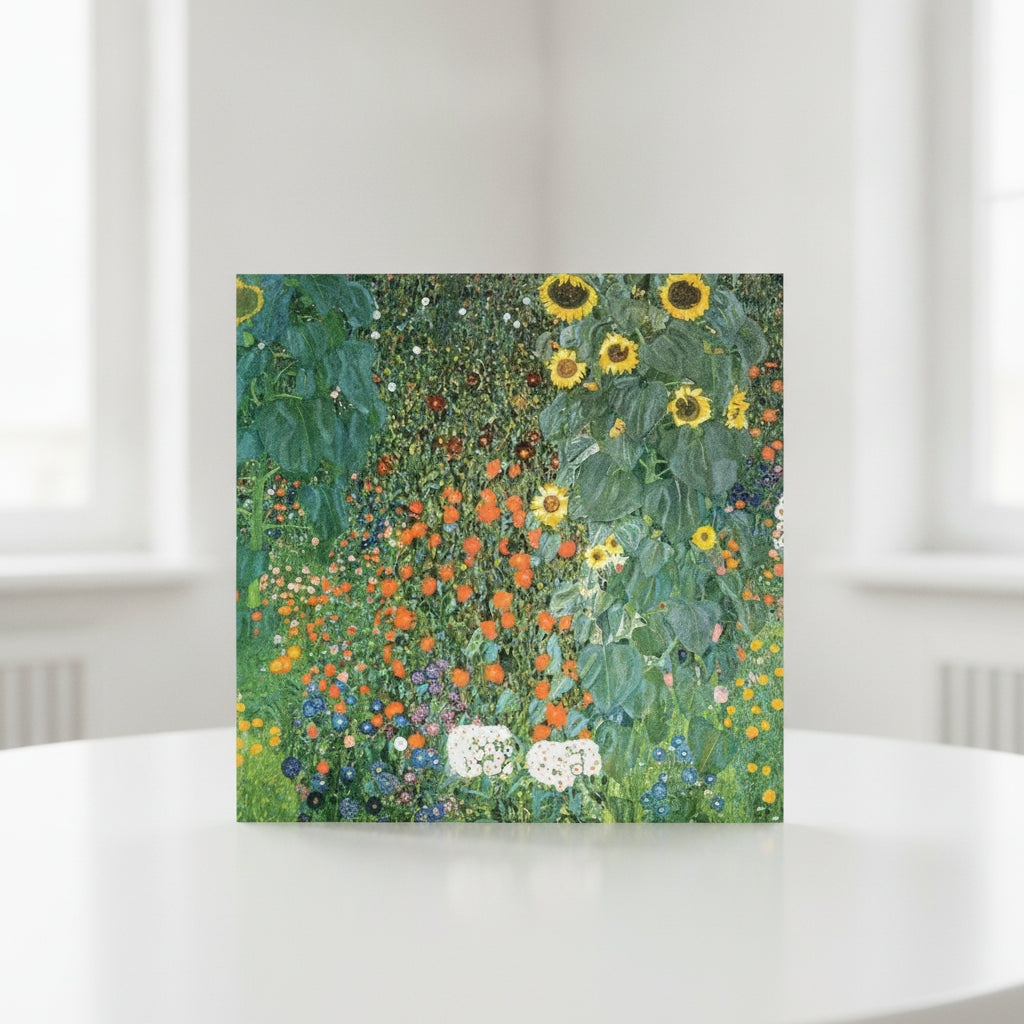 A square art print greeting card featuring Gustav Klimt's sunflower and wildflower painting, displayed on a white table.