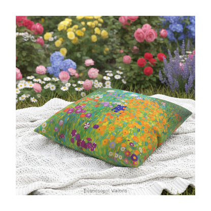 A square cushion pillow featuring a vibrant, impressionistic floral field design titled 'Bauerngarten' by Gustav Klimt, shown on a  blanket in a garden