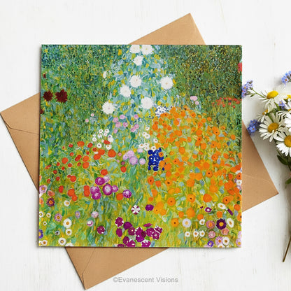 A square art print greeting card with Gustav Klimt arwork 'Bauergarten'   a colorful impressionist-style wildflower meadow, styled on top of brown envelope with a small bouquet of daisies on a white surface.