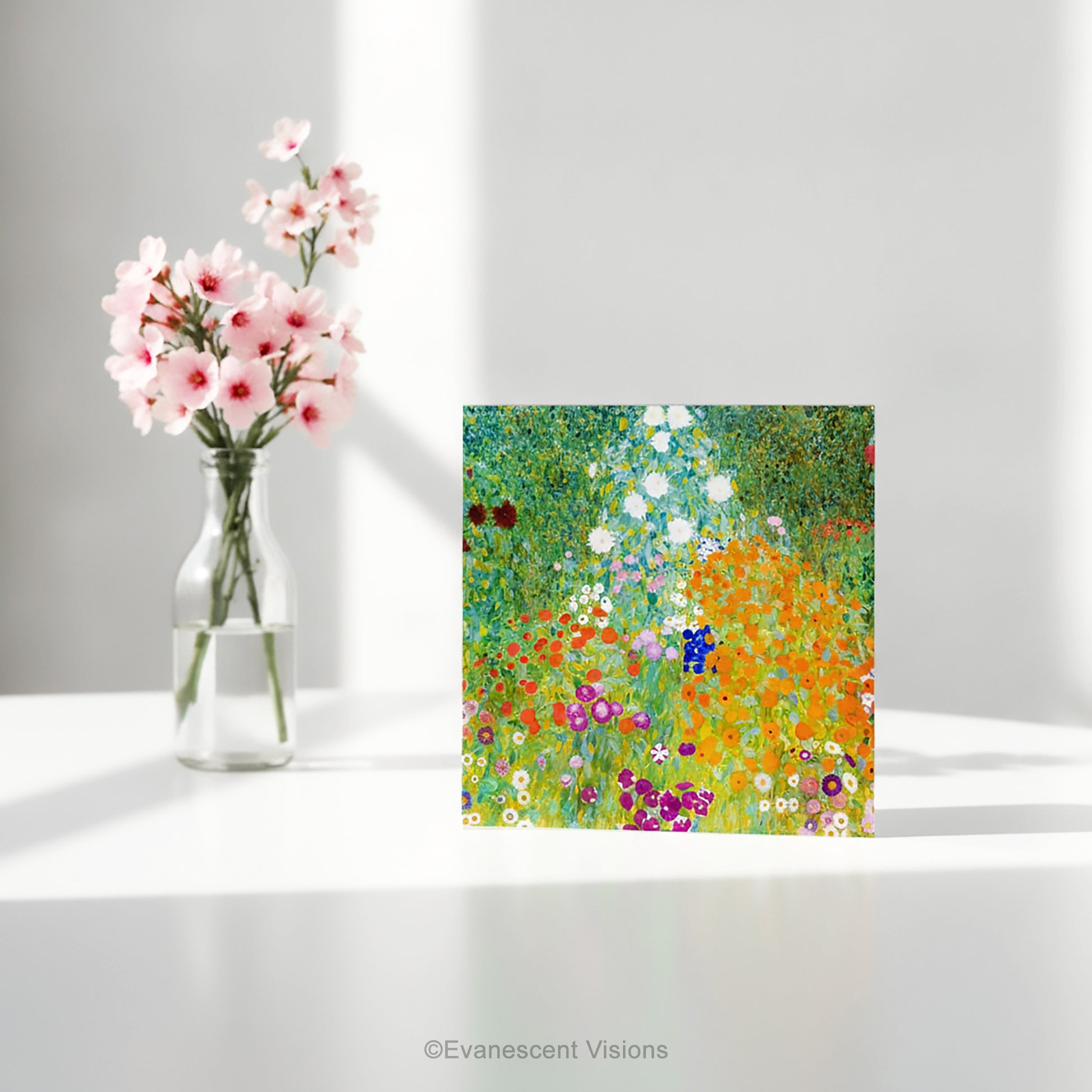 A square art print greeting card with Gustav Klimt arwork 'Bauergarten'   a colorful impressionist-style wildflower meadow, standing on a white table with a vase of flowers. 