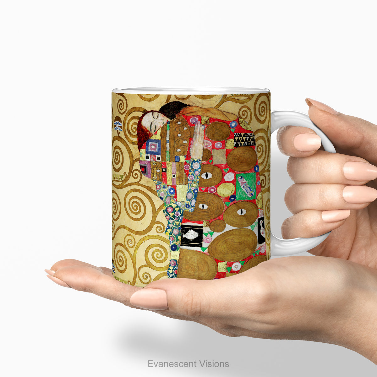 Hands holding a ceramic mug featuring Gustav Klimt's painting 'The Embrace'.