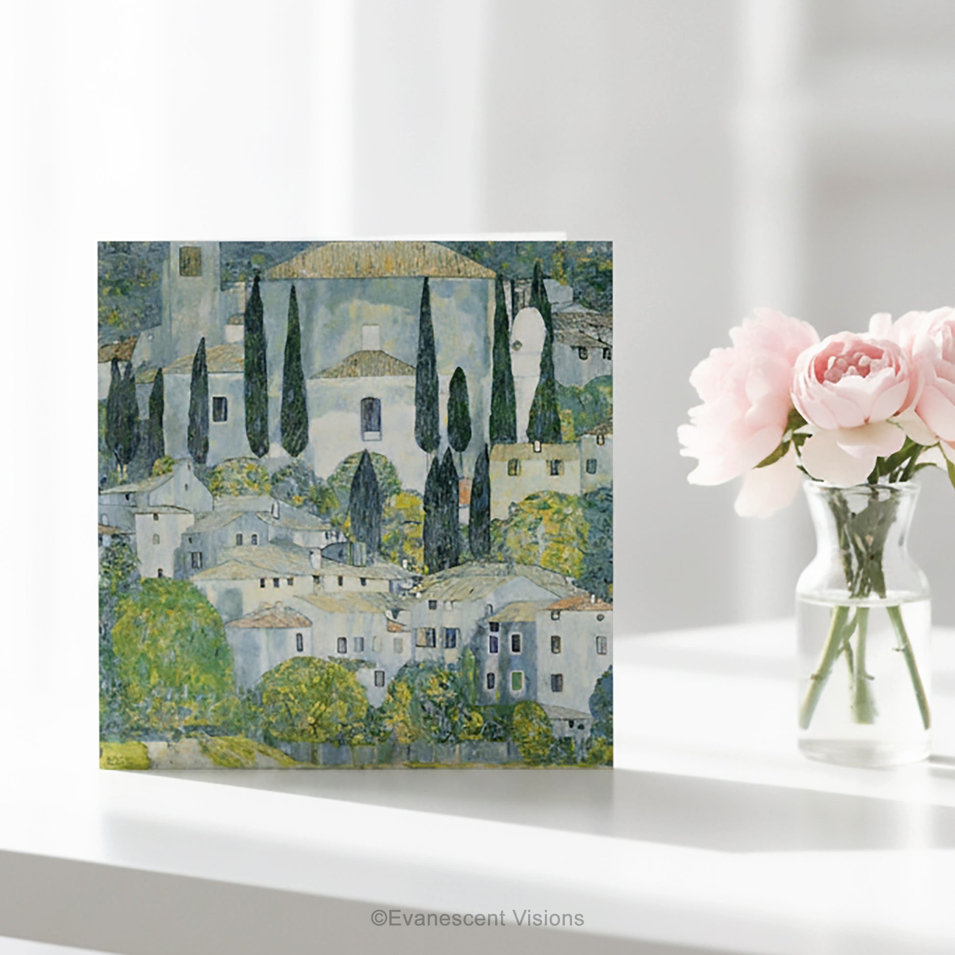 A square art greeting card on a table  featuring Gustav Klimt impressionistic painting 'Church at Cassone' a village scene with white buildings, green trees, and blue-gray sky.