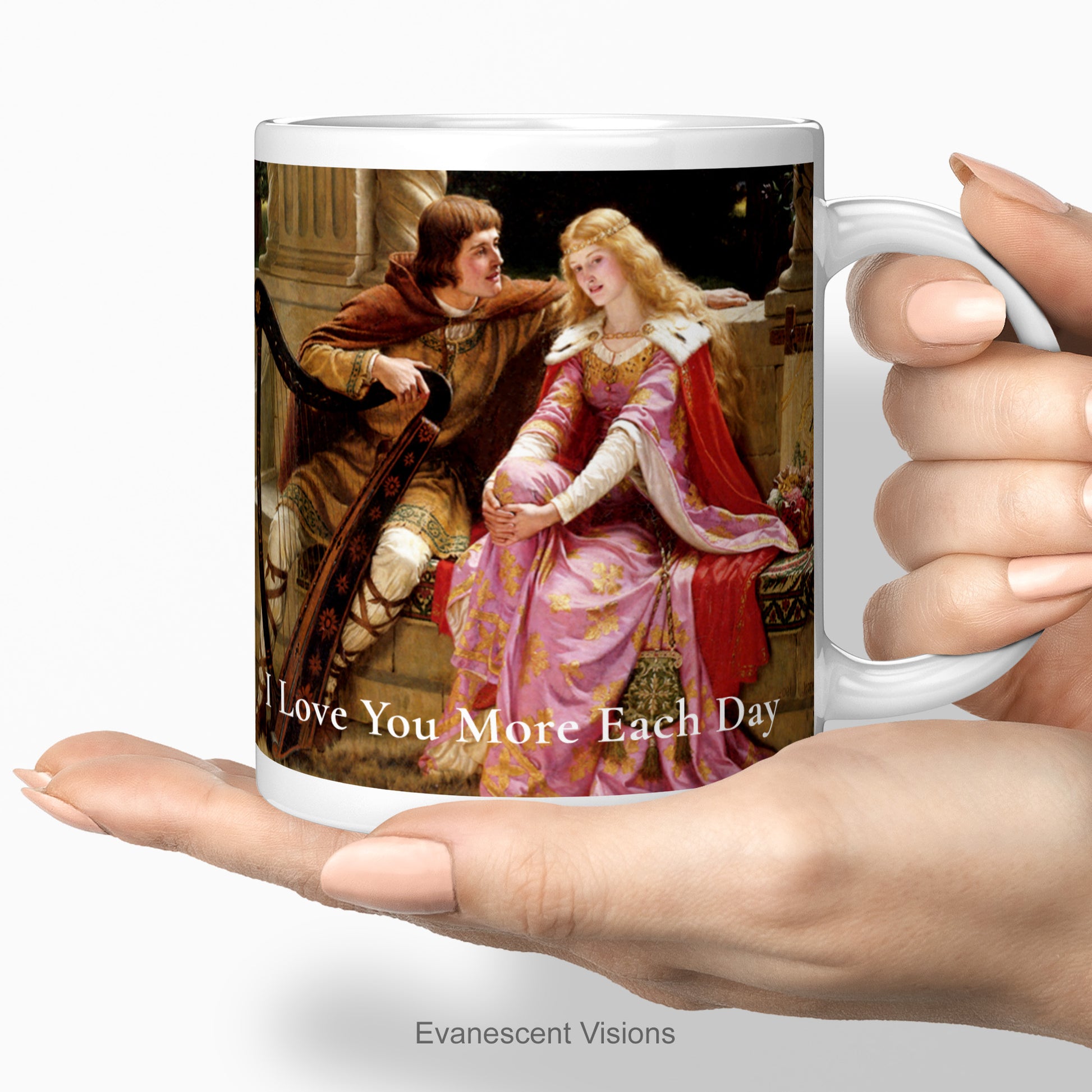 Ceramic mug with the image 'Tristan and Isolde (aka 'The End of the Song') by Edmund Blair Leighton (1852-1922) being held in two hands. The mug has an example of a personalised text, 'I love you more each day.'