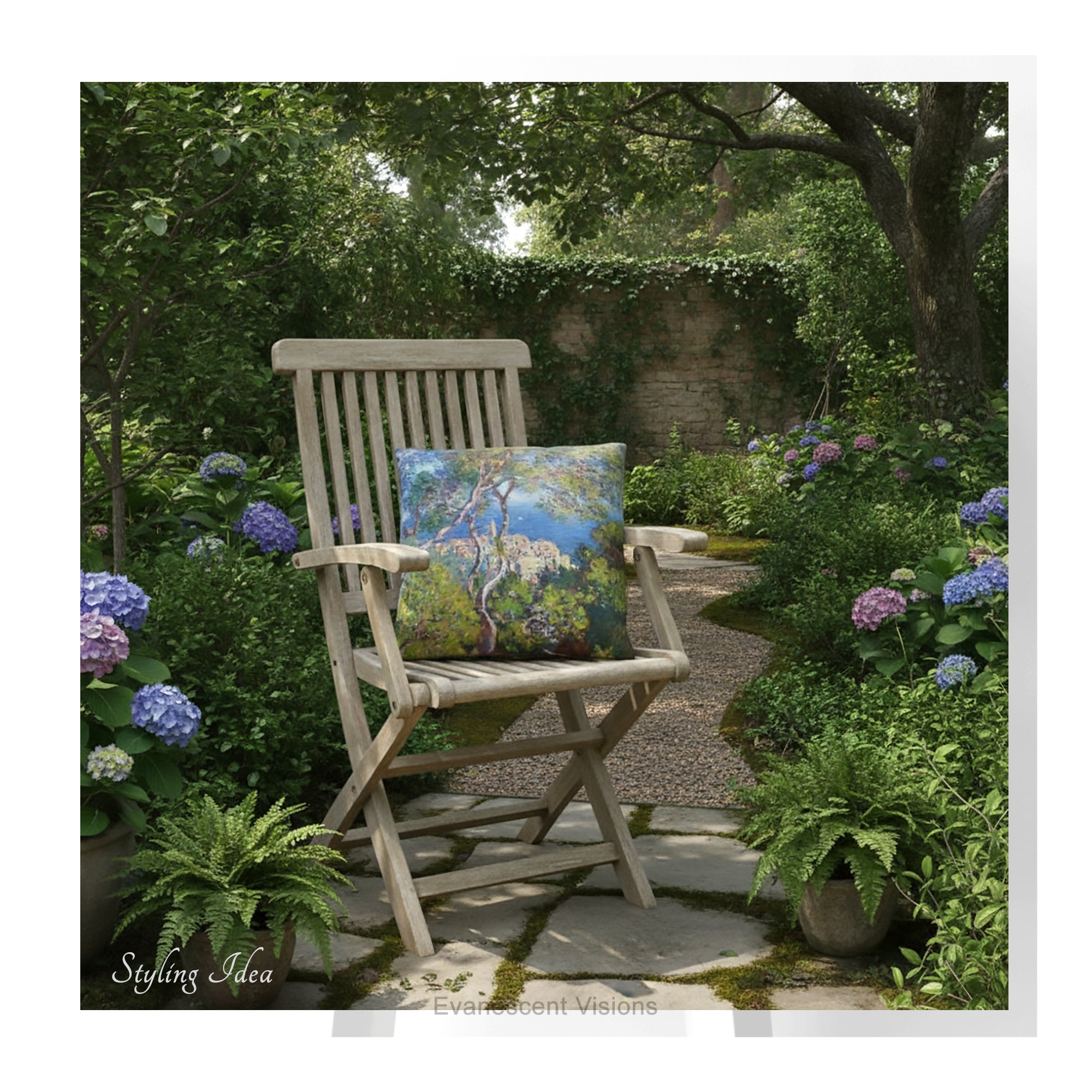 A square decorative cushion  printed with with Monet's Bordighera painting,  on a wooden garden chair in a garden. 