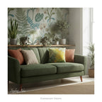 A decorative square cushion printed with impressionist floral painting 'The Path Through the Irises' by Claude Monet, on a green sofa in a botanical themed room. 