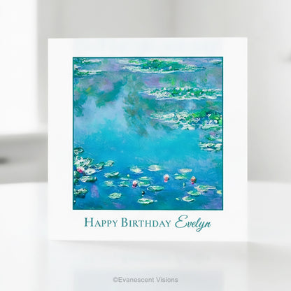 A square greeting card with a white border featuring Claude Monet's impressionist Water Lilies painting  in blue, green, and purple tones, with the text 'Happy Birthday Evelyn' printed below.