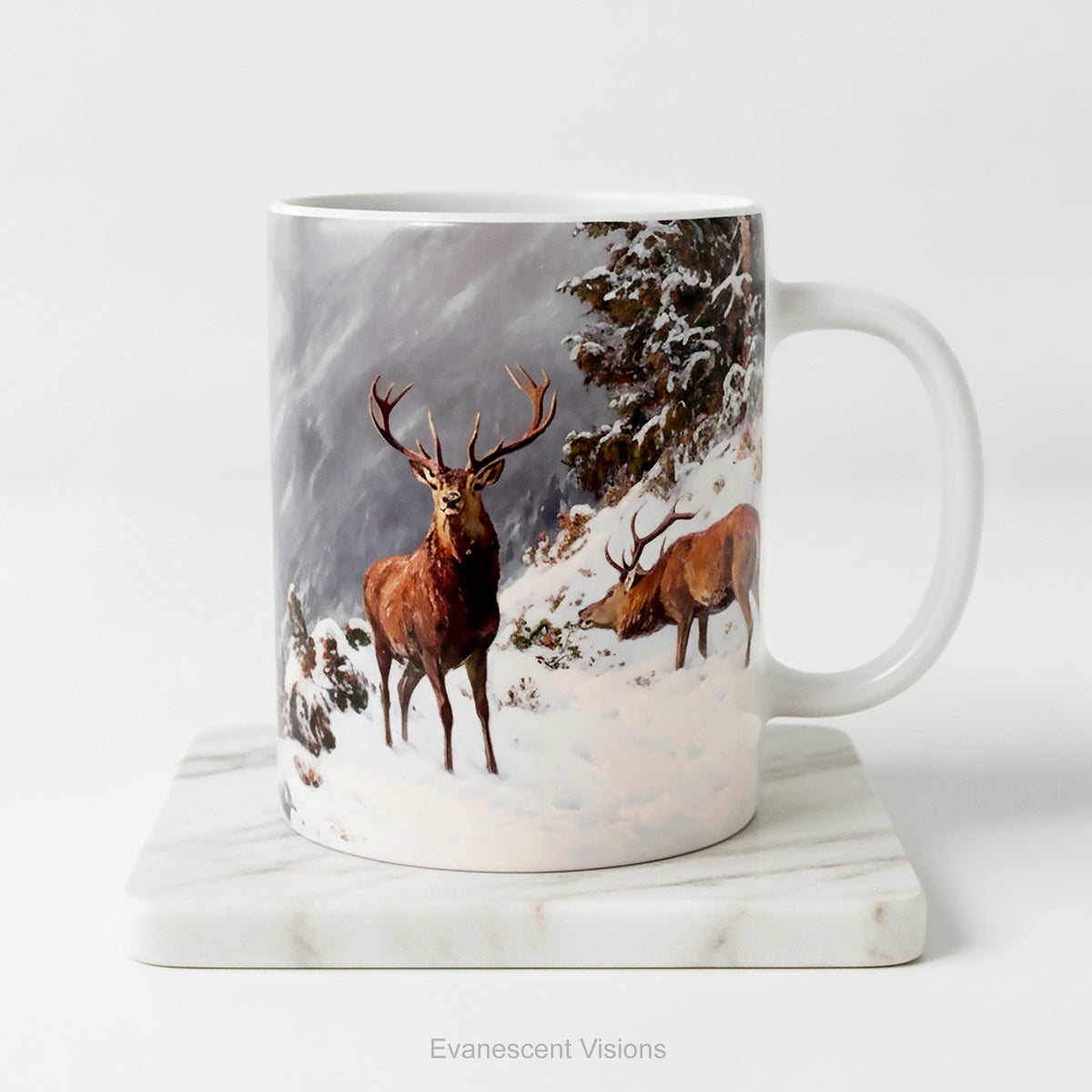 A white ceramic mug featuring artwork ' Red deer grazing in a mountainous winter landscape' by Arthur Thiele