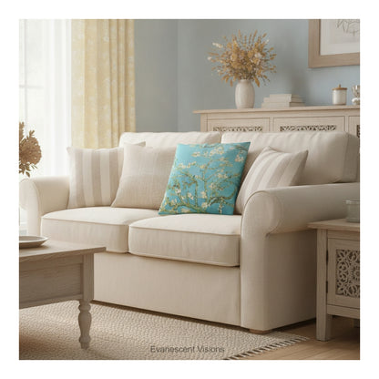 A square decorative cushion featuring Vincent van Gogh's 'Almond Blossom' painting design,  shown styled on a cream coloured sofa.