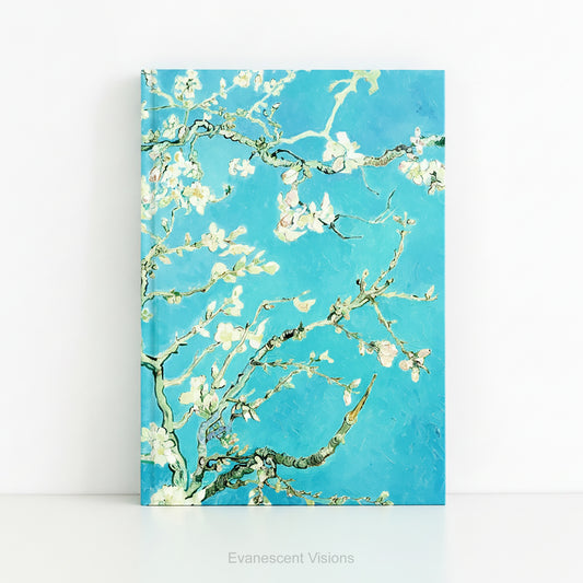 A hardback notebook with the floral impressionistic painting 'Almond Blossom' by an Gogh, shown against a white background. 