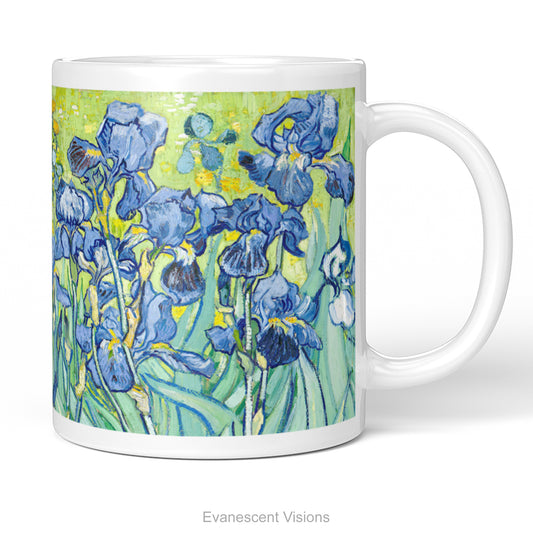 A white ceramic mug featuring a printed artwork of painting 'Irises' by Vincent Van Gogh, featuring blue irises against a textured yellow-green background, shown on a clean white studio background.