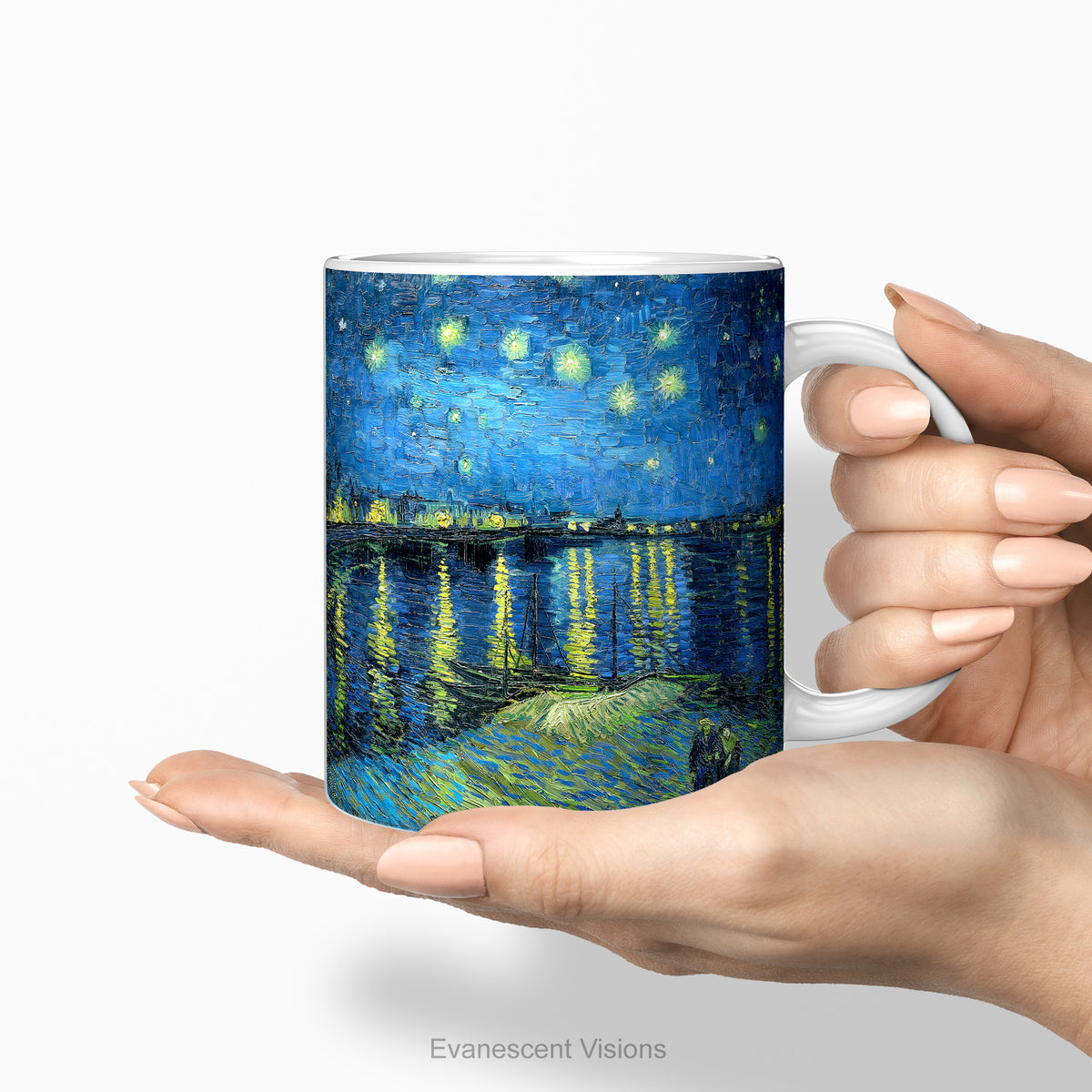 Hands holding a ceramic mug featuring artwork 'Starry Night Over the Rhône'.