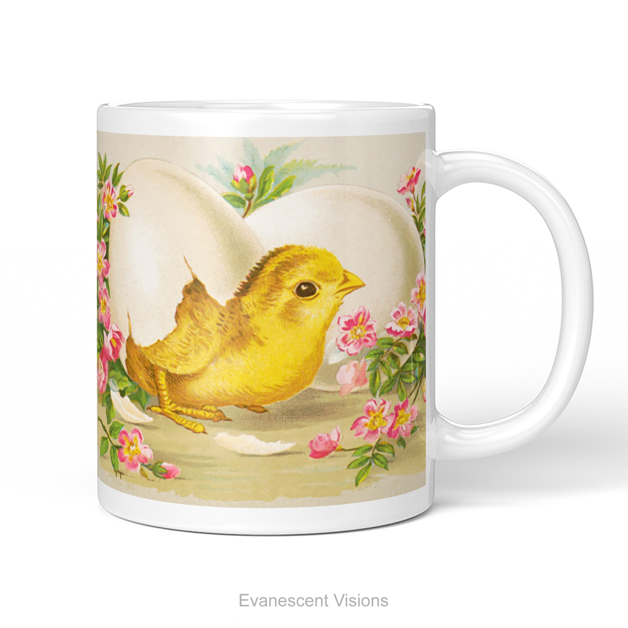 A white ceramic mug with a vintage design of a yellow Easter Chick breaking out of an egg surrounded by pink flowers and green leaves., shown on a white background.