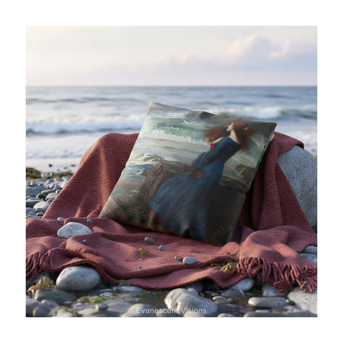 A decorative cushion featuring a print of the painting 'Miranda - The Tempest' by JW Waterhouse, shown on a red blanket on a rocky beach. 