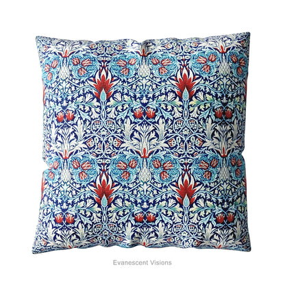 A square decorative cushion with red and blue botanical themed pattern entitled 'Snakeshead' by William Morris.  