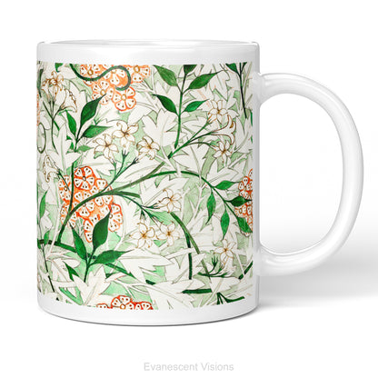 A white ceramic mug featuring a botanical pattern of white and orange flowers, green leaves,  titled 'Jasmin by William Morris, shown on a white background. 