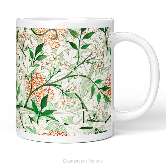 A white ceramic mug featuring a botanical pattern of white and orange flowers, green leaves,  titled 'Jasmin by William Morris, shown on a white background. 