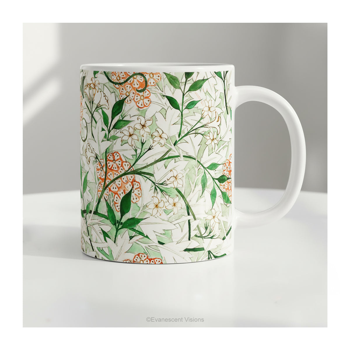 A ceramic mug featuring botanical pattern  'Jasmin'  by William Morris on a table.