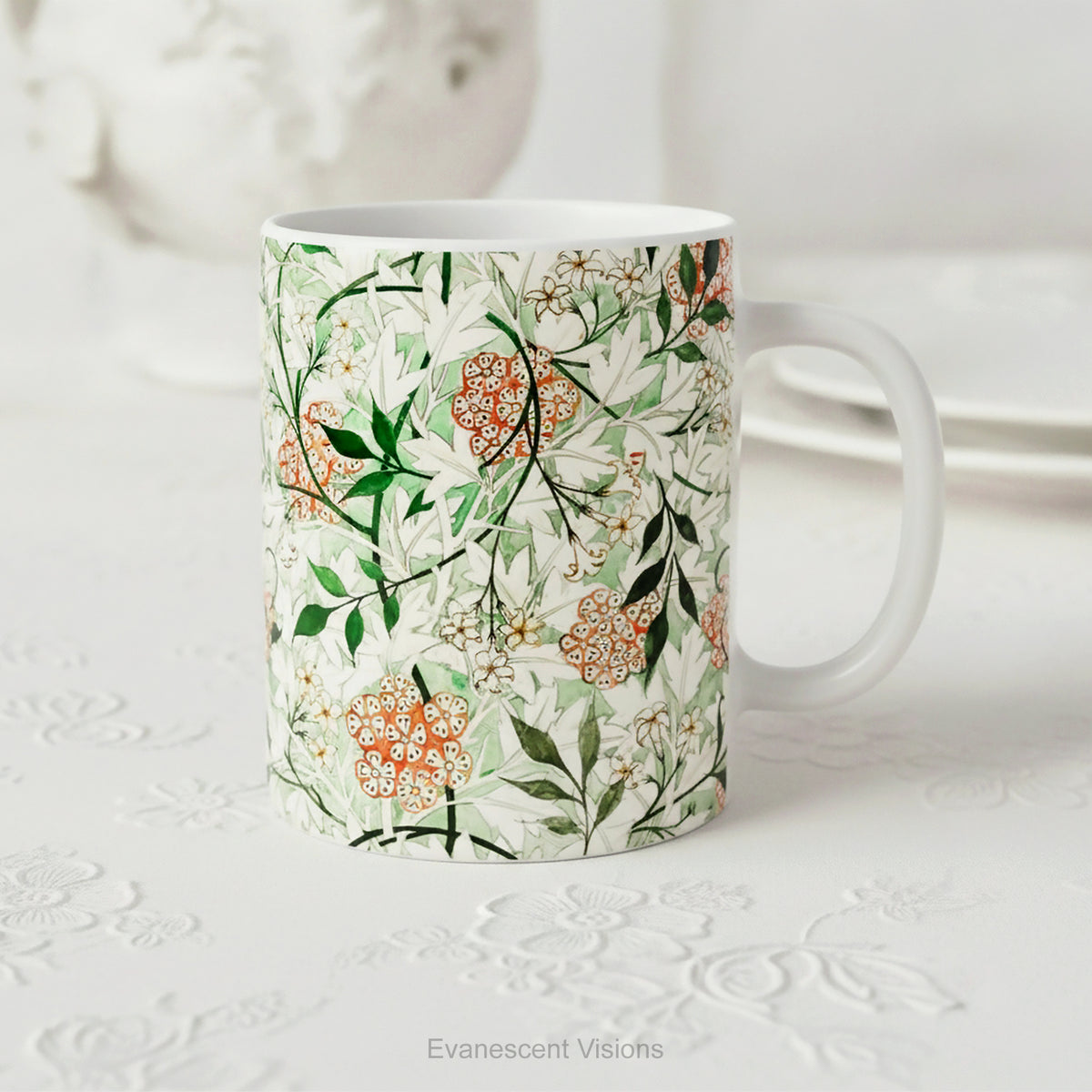 A ceramic mug featuring botanical pattern  'Jasmin', styled on a white floral table. 