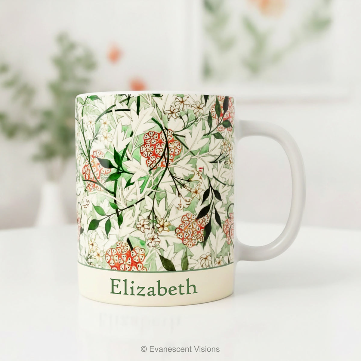 A personalised name ceramic mug featuring a botanical design 'Jasmin' by William Morris, styled on a table.