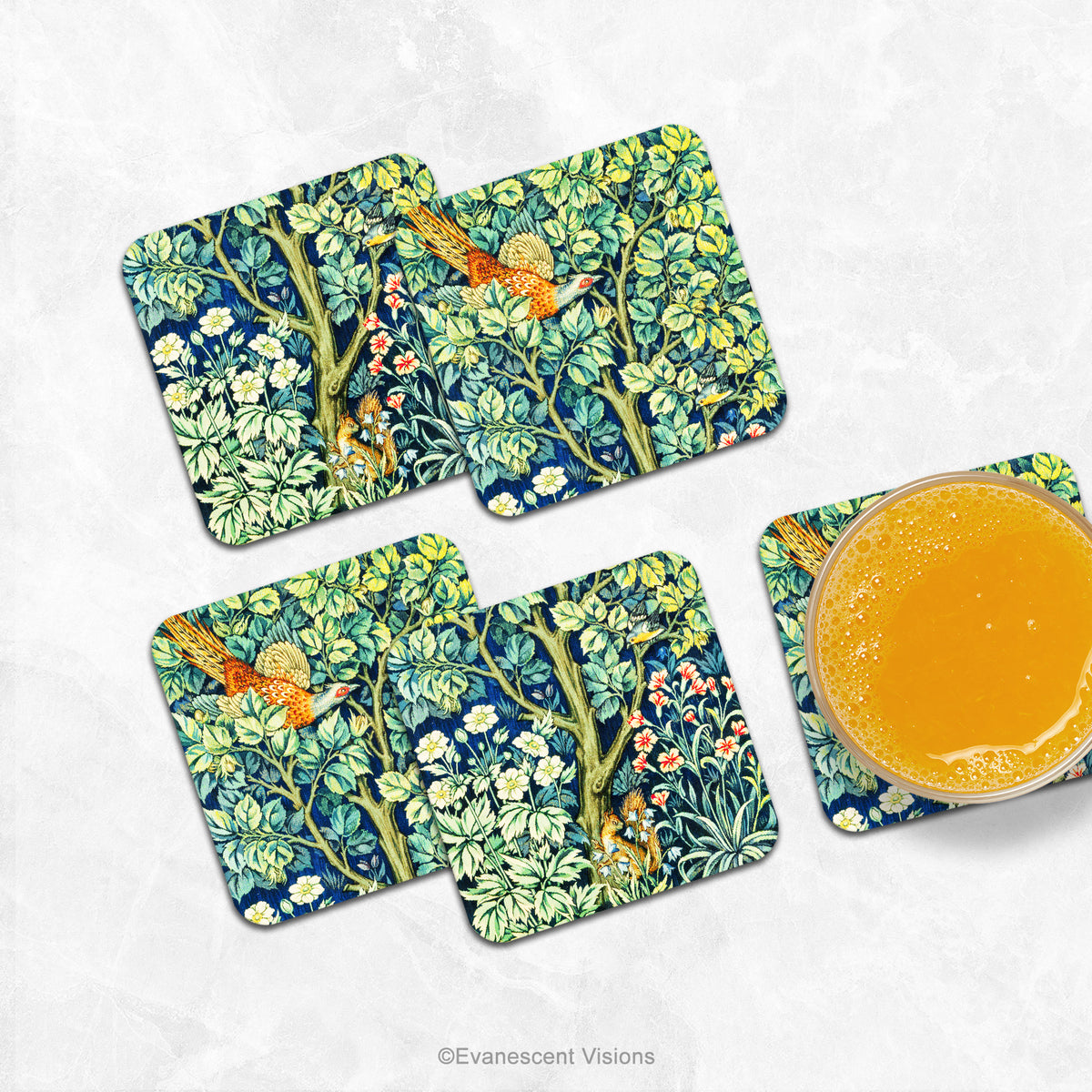 Set of four coasters printed with detail from the design  'Cock Pheasant' by William Morris, shown on a marble counter with a glass of orange
