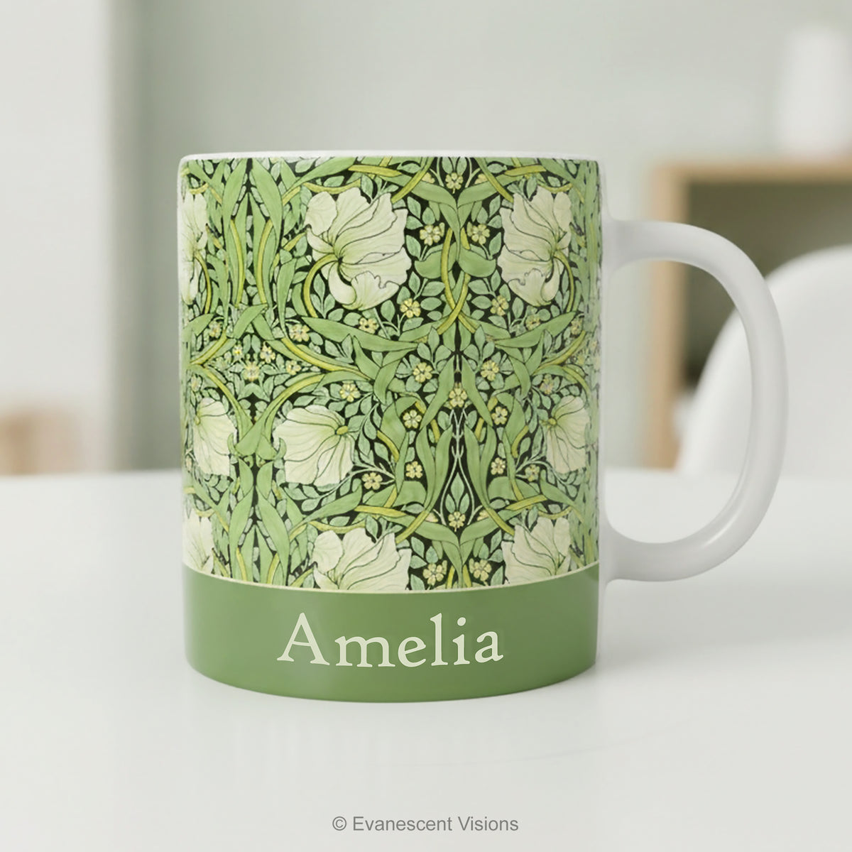 Ceramic mug with William Morris's 'Pimpernel' floral design and personalisation, styled on a table. 