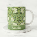 Ceramic mug with William Morris's 'Pimpernel' floral design in green, and a name below