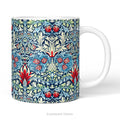 A  ceramic mug featuring a print of floral pattern 'Snakeshead' by William Morris.