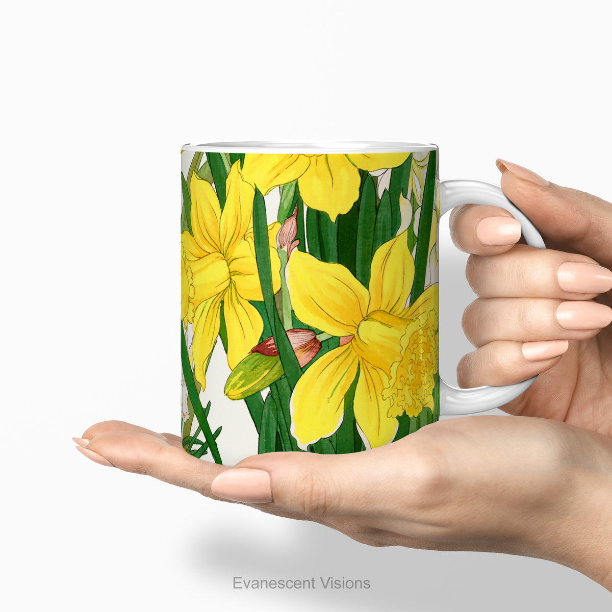 Hands holding a ceramic mug with a print of painting of 'Spring Daffodil Flowers'